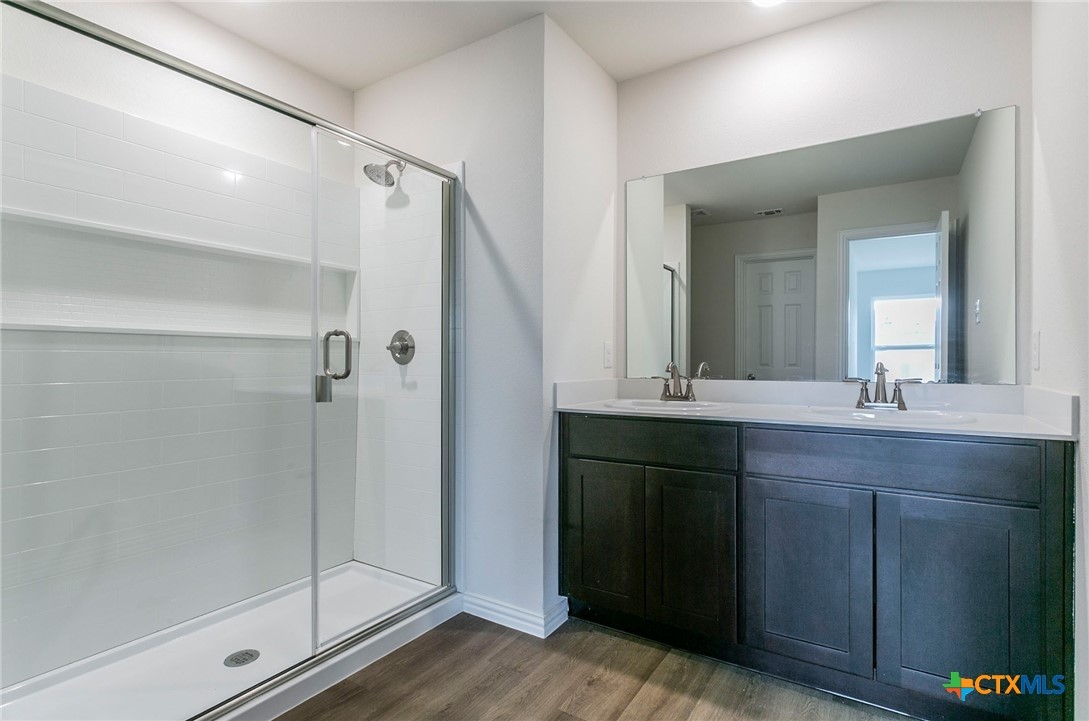 3009 Gillespie Court Temple, TX 76501 - Photo 9 of 13 a bathroom with a double vanity sink mirror and shower