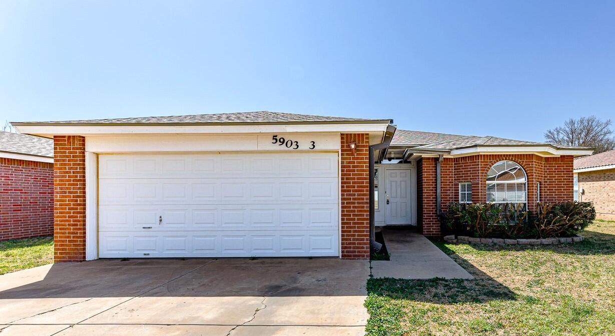 5903 10th Street, Unit 3 Lubbock, TX 79416 - Photo 1 of 32 a view of a house with a yard