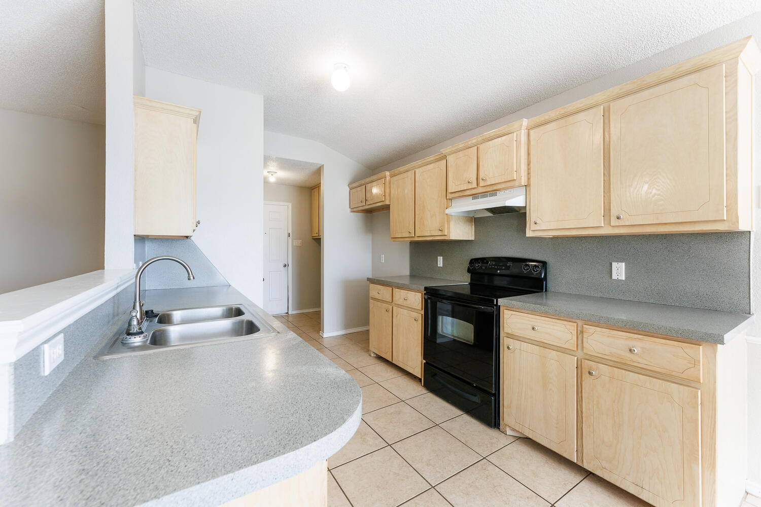 5903 10th Street, Unit 3 Lubbock, TX 79416 - Photo 15 of 32 a kitchen with granite countertop a sink stove and cabinets