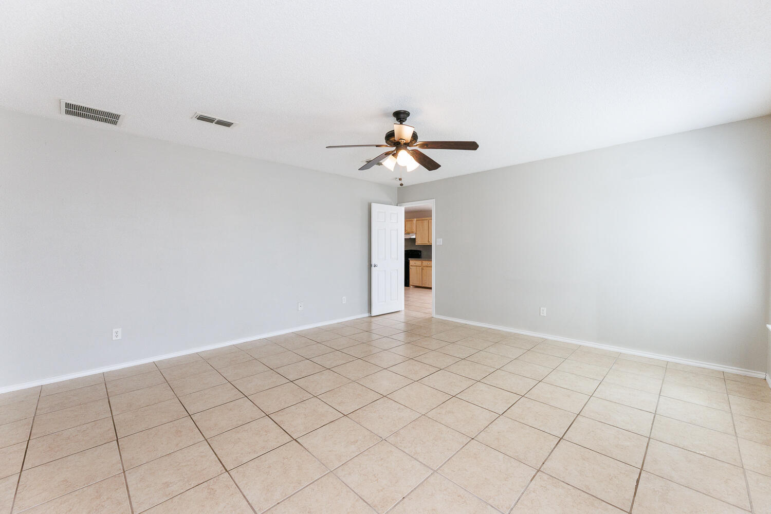 5903 10th Street, Unit 3 Lubbock, TX 79416 - Photo 19 of 32 a view of an empty room and chandelier fan