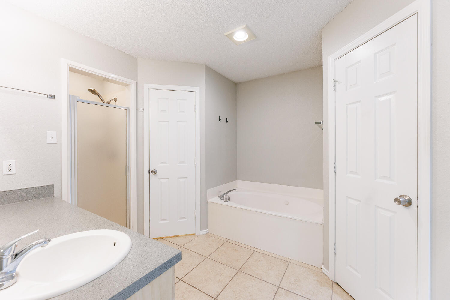 5903 10th Street, Unit 3 Lubbock, TX 79416 - Photo 20 of 32 a bathroom with a tub a toilet and a sink
