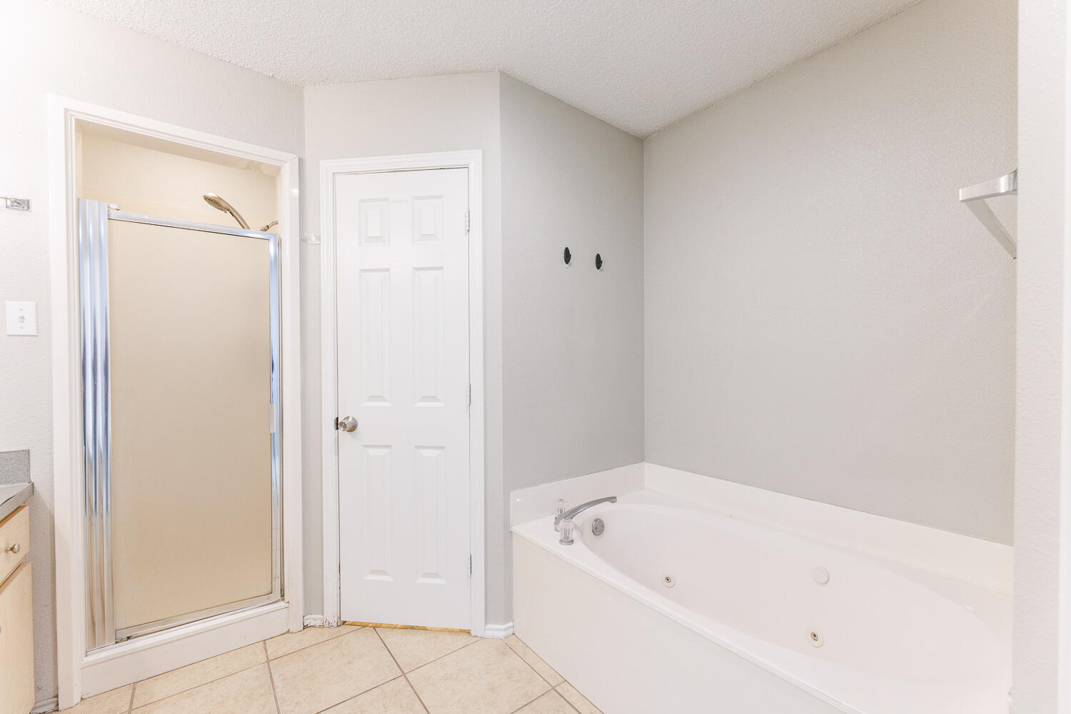 5903 10th Street, Unit 3 Lubbock, TX 79416 - Photo 21 of 32 a white bath tub sitting next to a shower