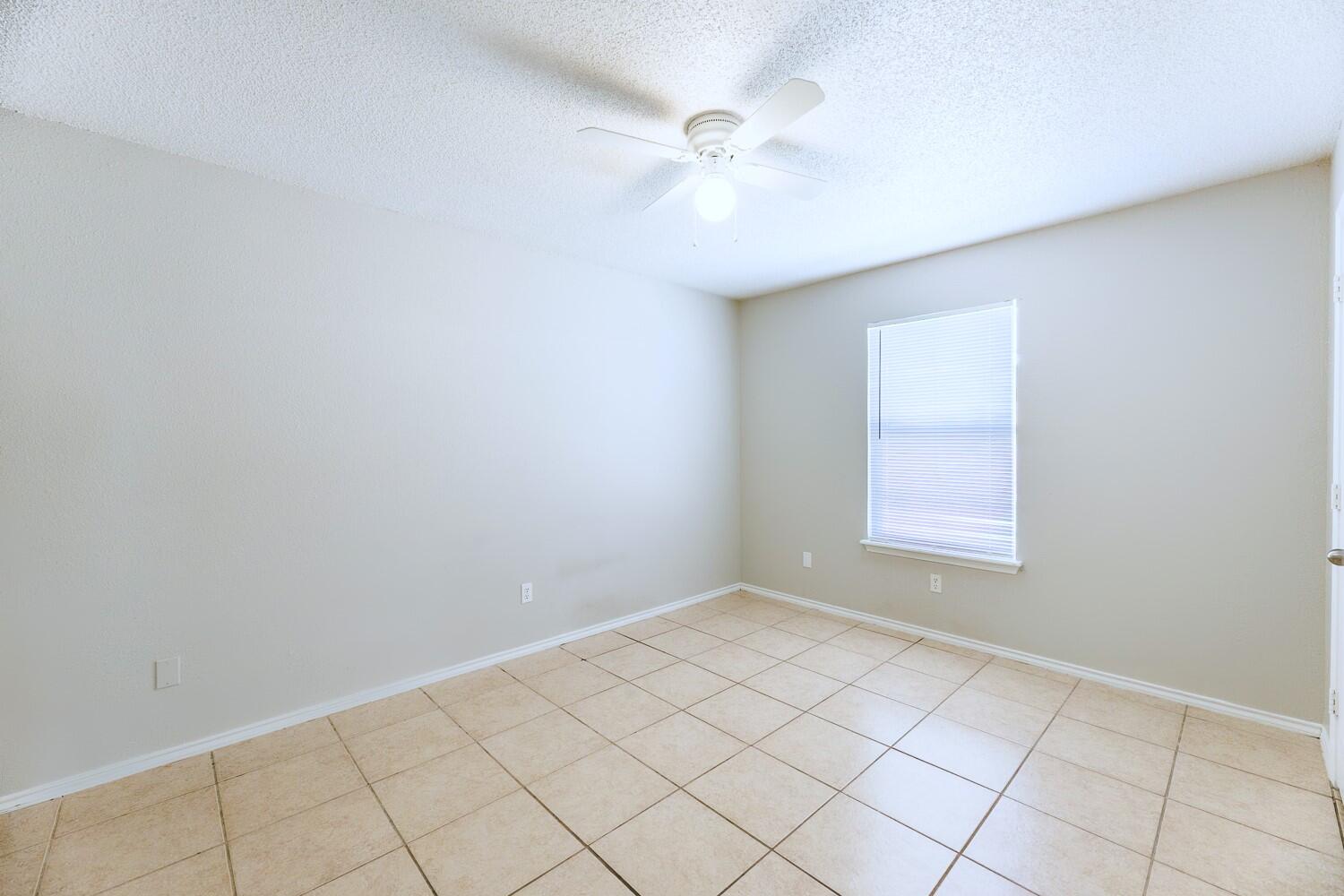 5903 10th Street, Unit 3 Lubbock, TX 79416 - Photo 26 of 32 an empty room with windows and fan
