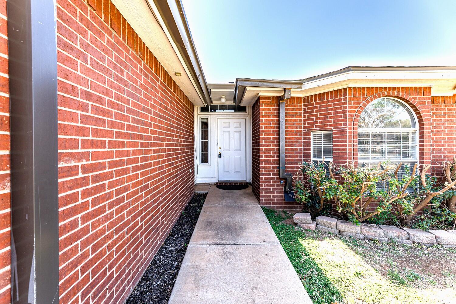 5903 10th Street, Unit 3 Lubbock, TX 79416 - Photo 3 of 32 a view of a pathway both side of house