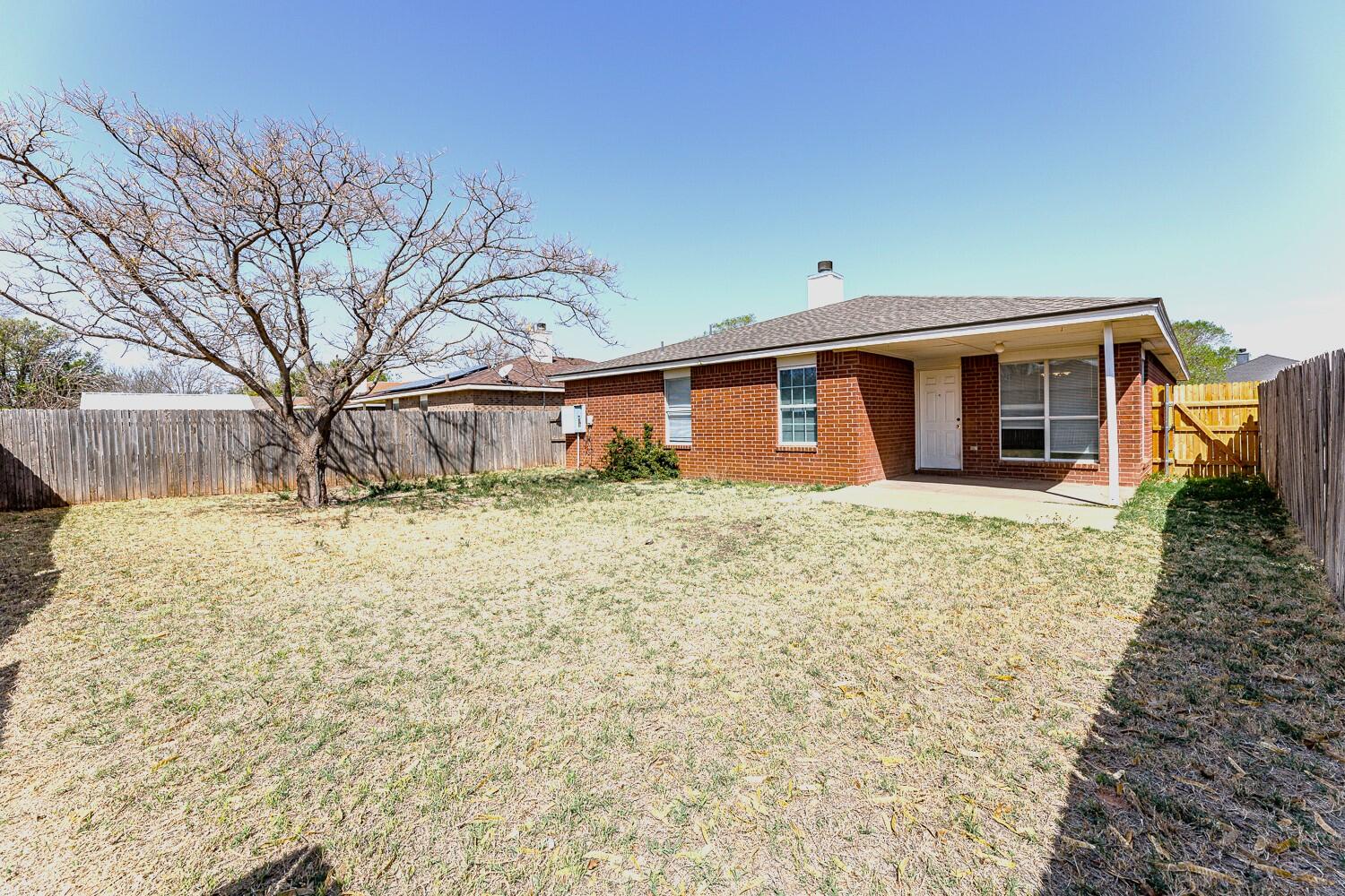 5903 10th Street, Unit 3 Lubbock, TX 79416 - Photo 31 of 32 a front view of house with yard