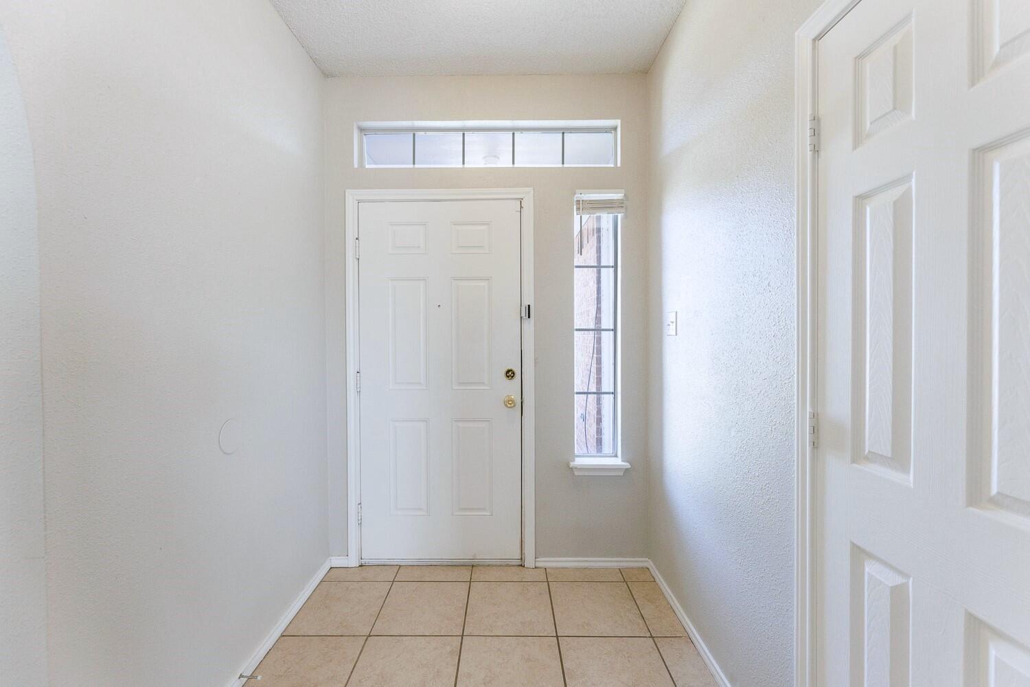 5903 10th Street, Unit 3 Lubbock, TX 79416 - Photo 5 of 32 a view of an empty room with closet and a window