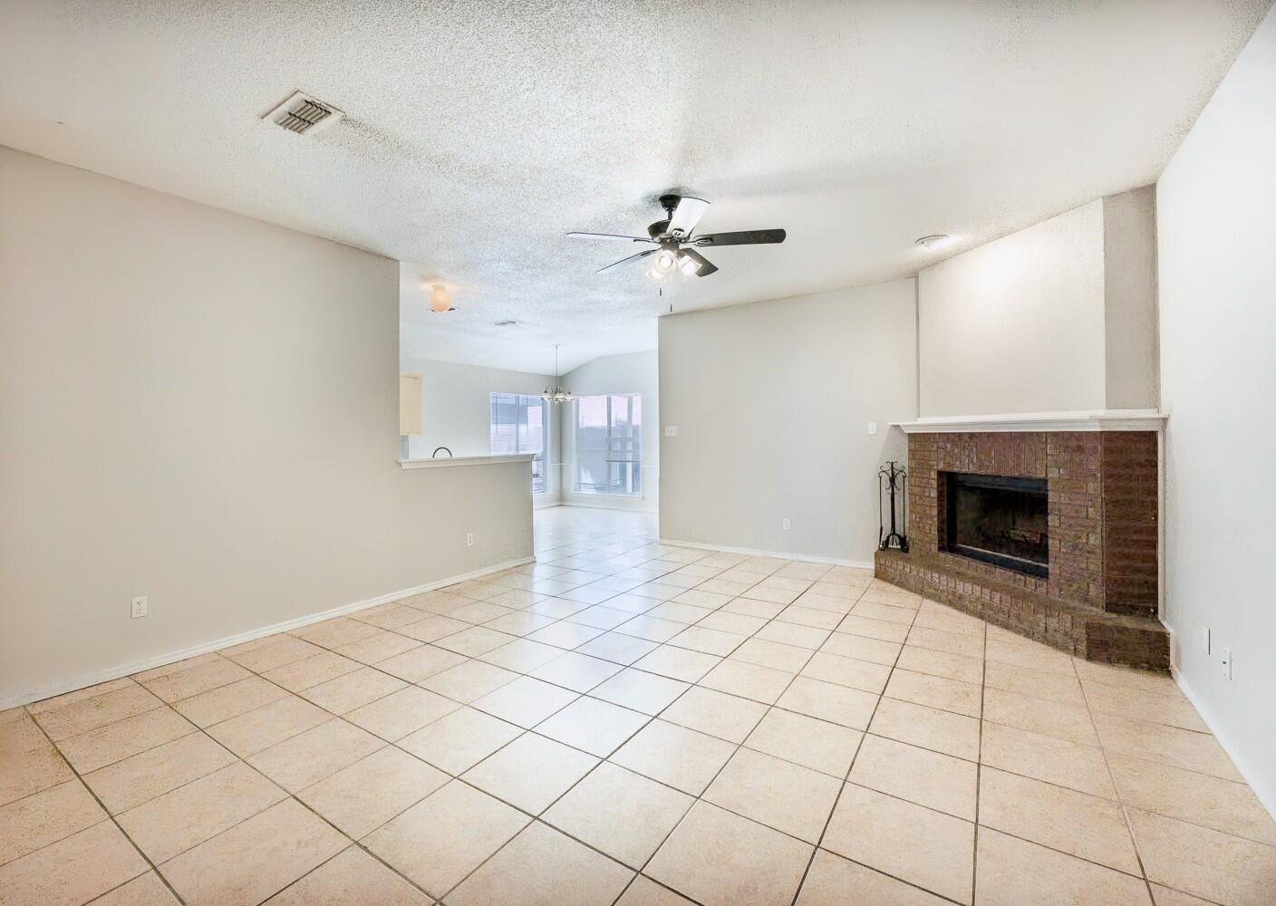 5903 10th Street, Unit 3 Lubbock, TX 79416 - Photo 7 of 32 a view of an empty room with a fireplace