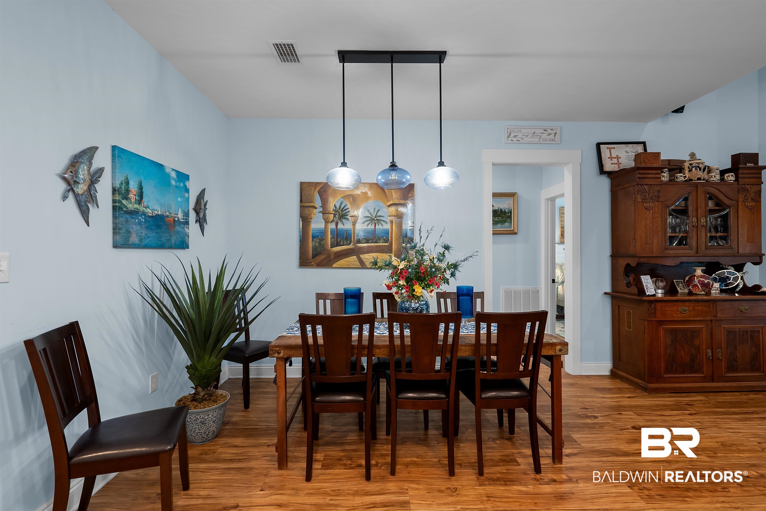7266 Franklin Road Foley, AL 36535 - Photo 19 of 64 Dining area featuring wood-finish flooring, light blue wall paint, and a linear pendant light fixture