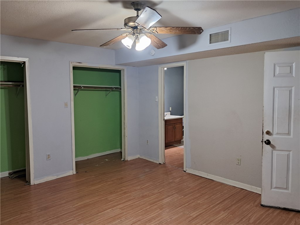 1202 Cheyenne Drive Brenham, TX 77833 - Photo 3 of 9 an empty room with wooden floor a ceiling fan