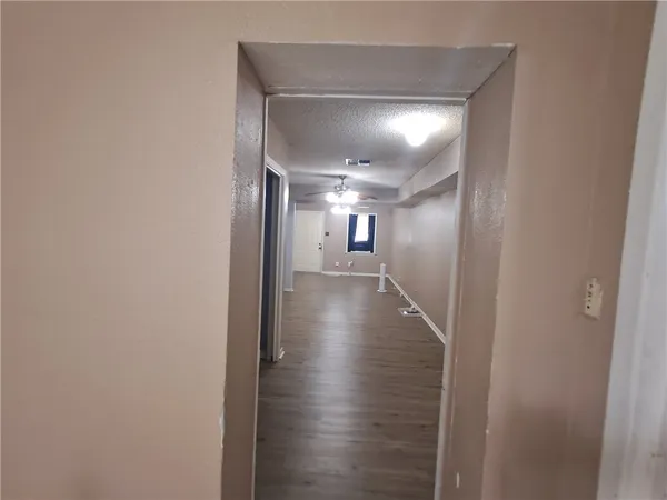 a view of hallway with wooden floor