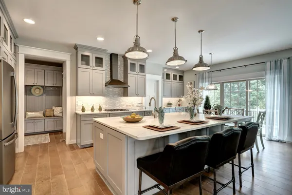 a kitchen with a stove a sink a dining table and chairs