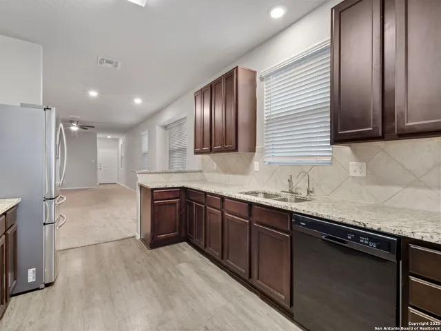 a spacious bathroom with a granite countertop sink and a mirror