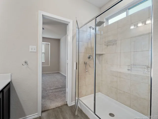a bathroom with a glass shower door