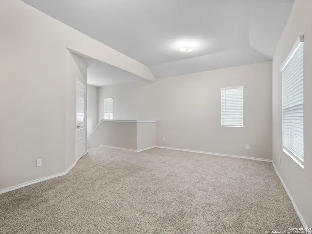 an empty room with windows and closet