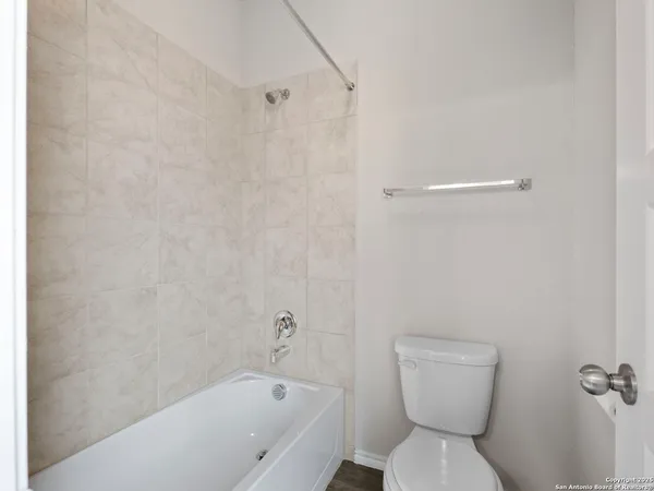 a bathroom with a toilet and a bathtub