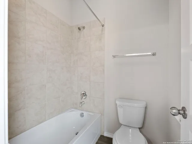 a bathroom with a toilet and a bathtub