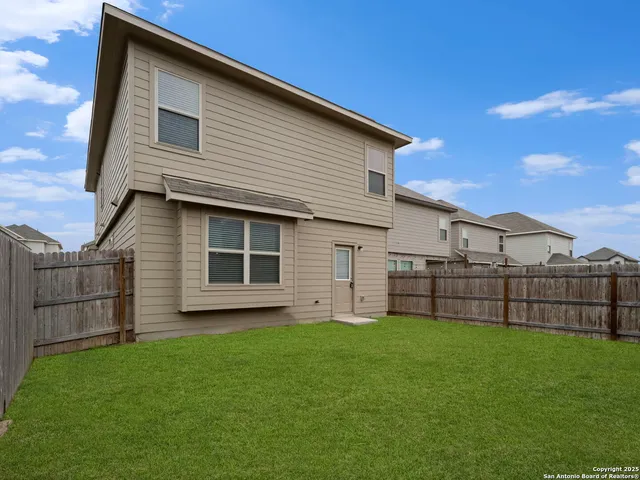a view of a house with a yard and sitting area