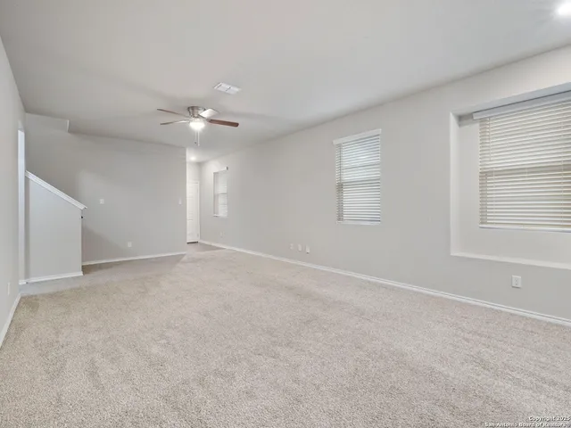 a view of an empty room with a window