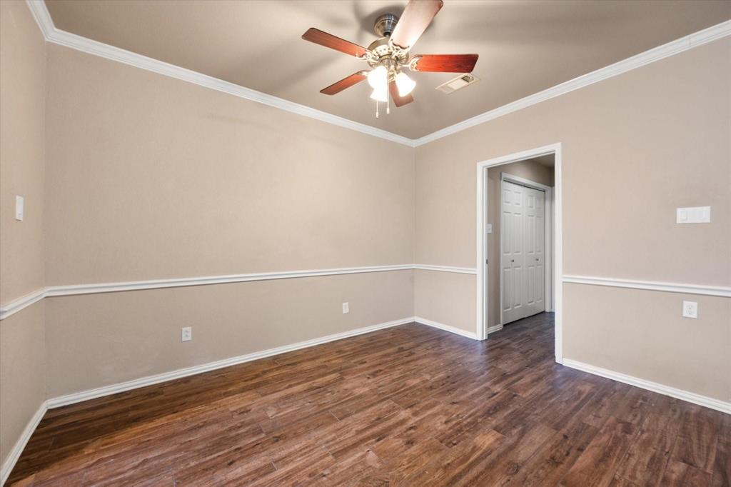 2312 Perkins Road Arlington, TX 76016 - Photo 11 of 29 Dining area featuring wood-finish flooring, crown molding, chair rail molding, and a ceiling fan