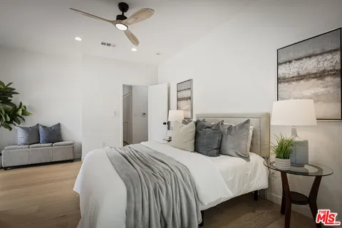 a bedroom with bed and a couch