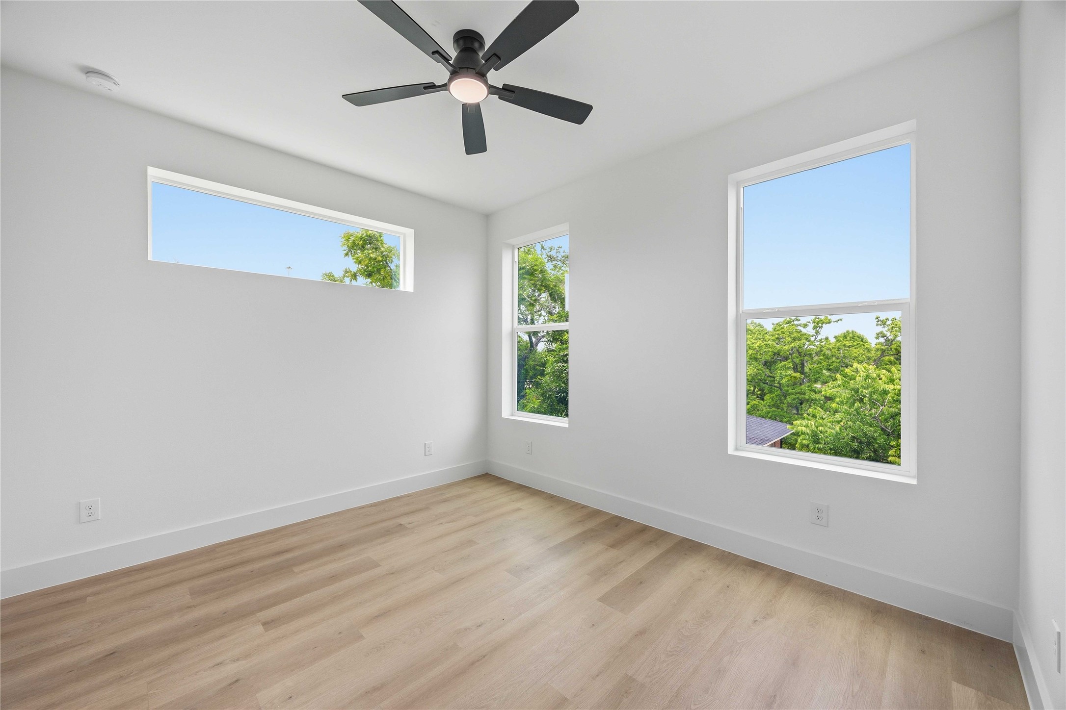 3103 Lelia Street, Unit A Houston, TX 77026 - Photo 18 of 30 wooden floor in an empty room with a window
