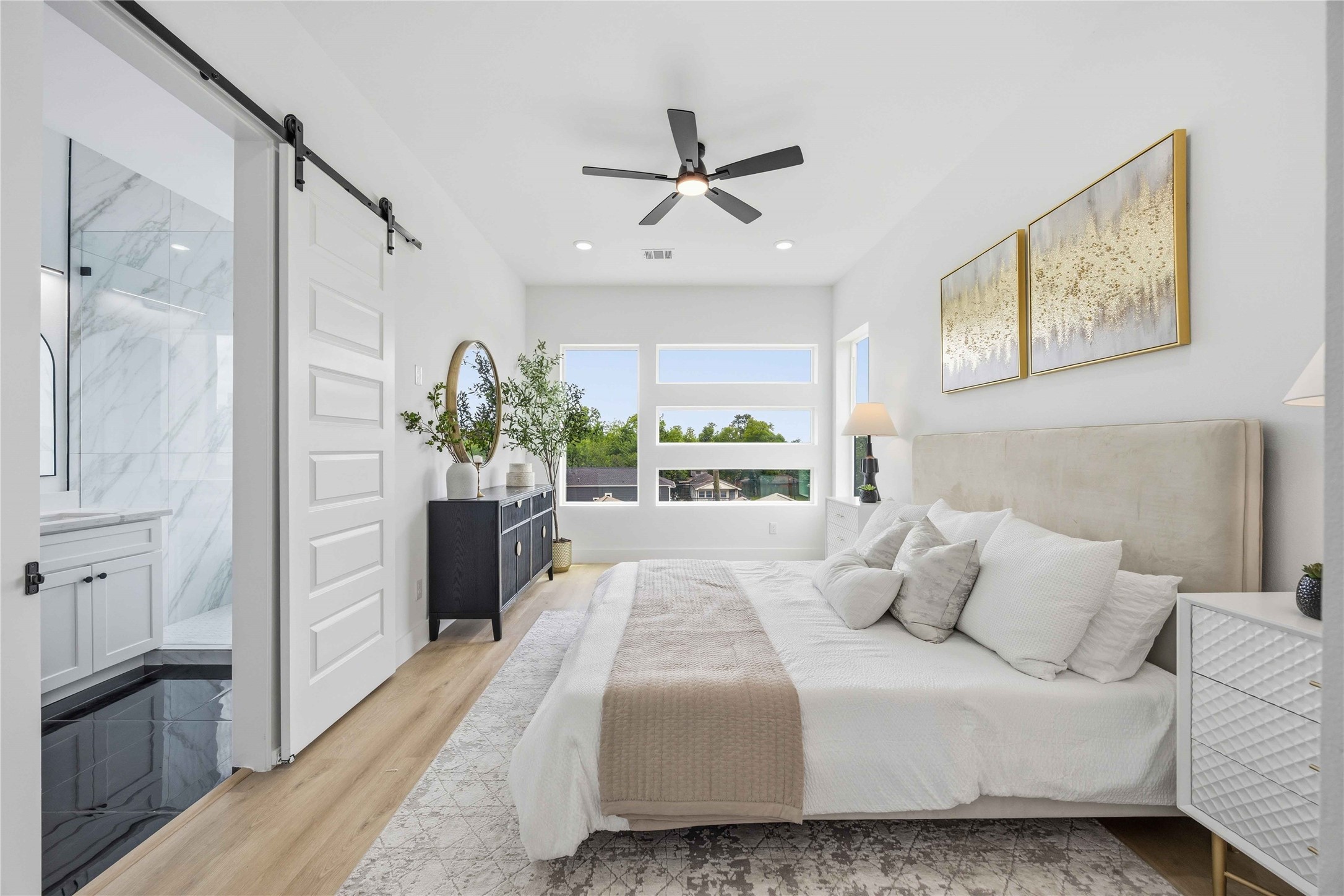 3103 Lelia Street, Unit A Houston, TX 77026 - Photo 21 of 30 a bedroom with a large bed and a chandelier