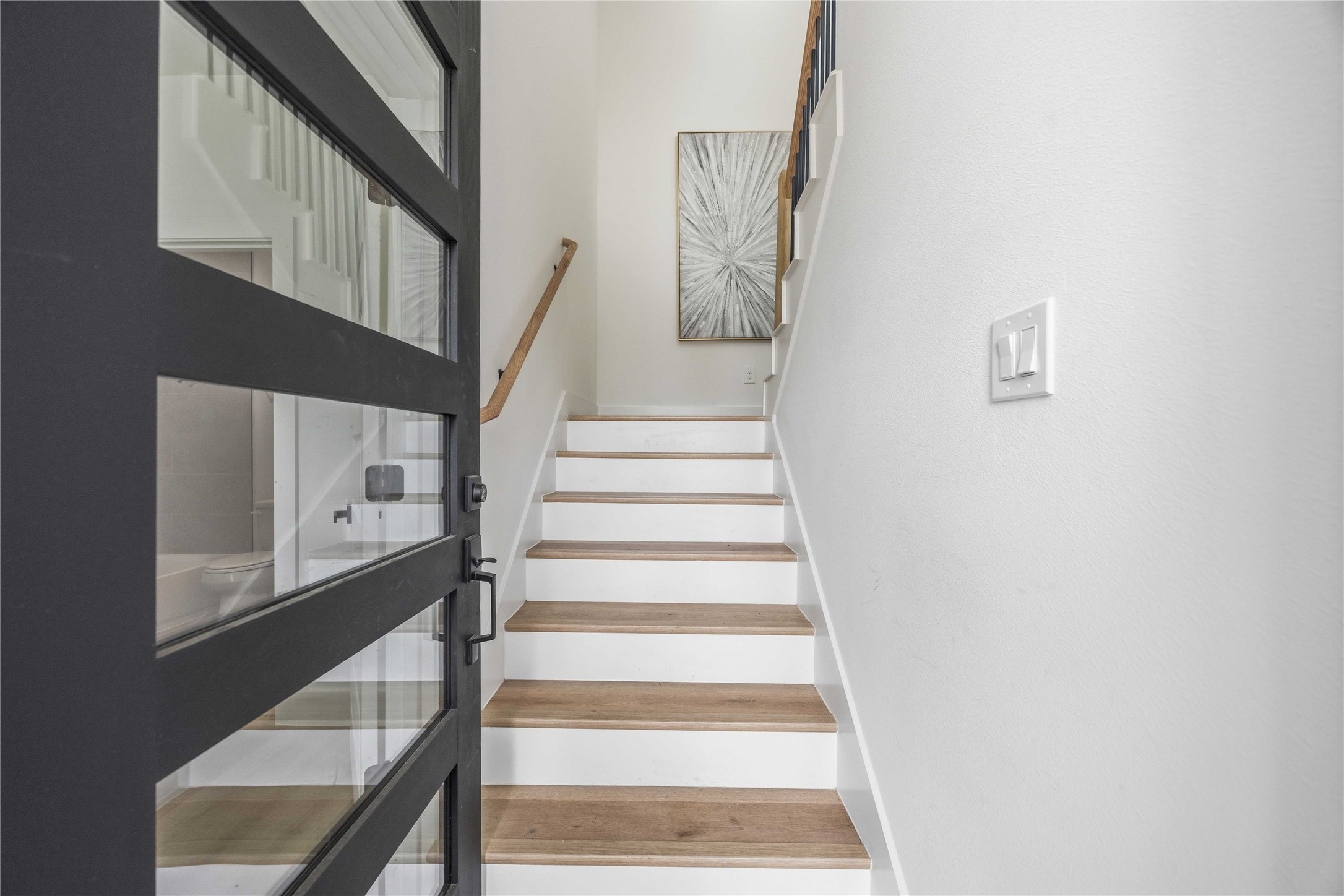 3103 Lelia Street, Unit A Houston, TX 77026 - Photo 5 of 30 a view of staircase with white walls and a black wall painting