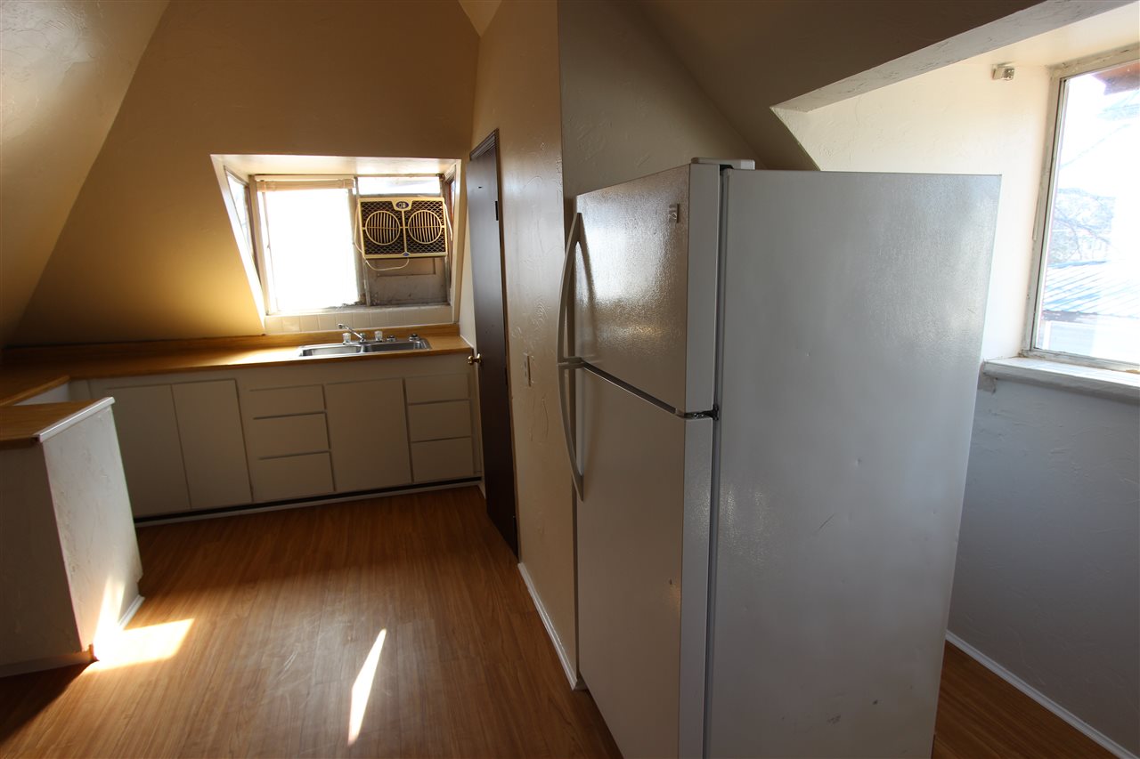 1011 Rood Avenue, Unit C Grand Junction, CO 81501 - Photo 3 of 8 a kitchen with stainless steel appliances granite countertop a refrigerator and a sink
