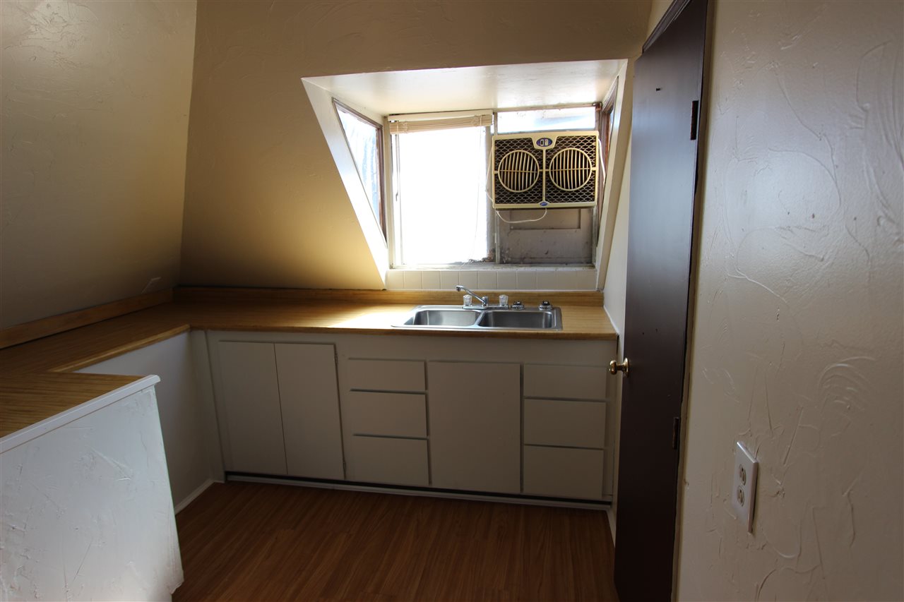 1011 Rood Avenue, Unit C Grand Junction, CO 81501 - Photo 4 of 8 a kitchen with a sink window and cabinets