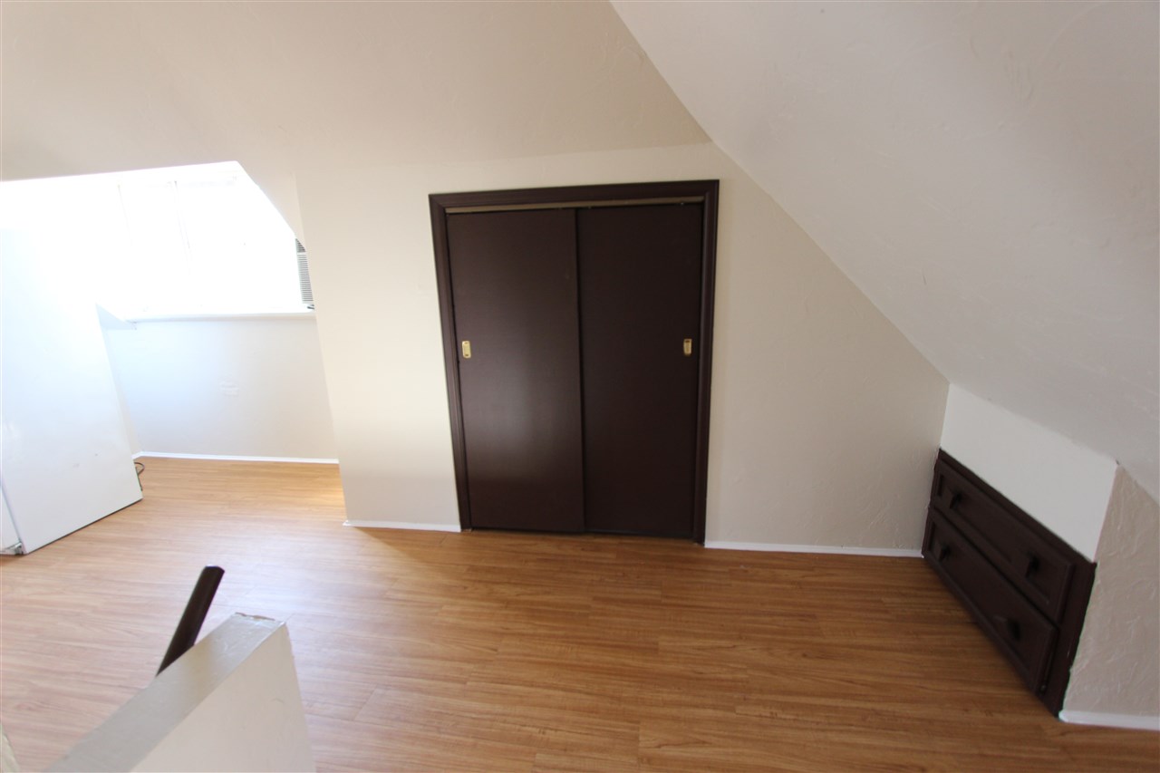 1011 Rood Avenue, Unit C Grand Junction, CO 81501 - Photo 5 of 8 a view of empty room with wooden floor