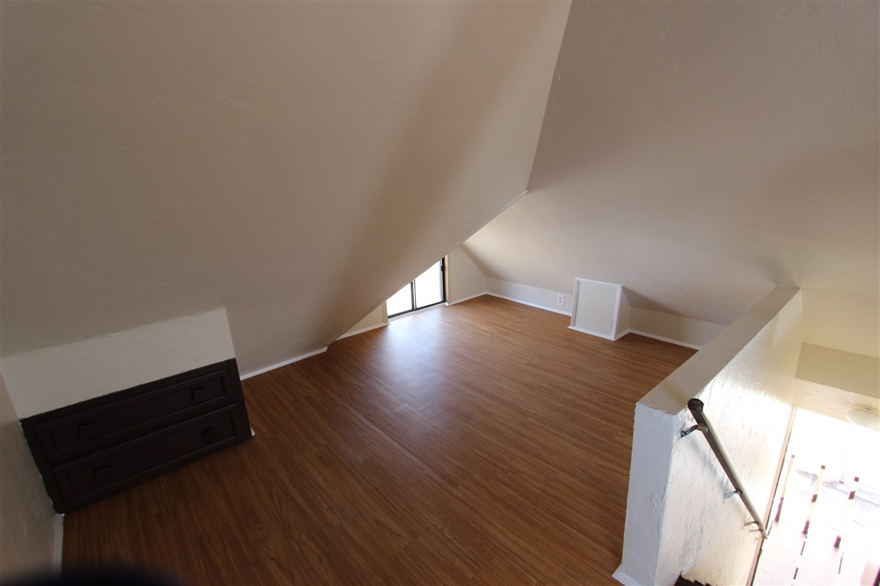 1011 Rood Avenue, Unit C Grand Junction, CO 81501 - Photo 6 of 8 a view of an empty room and wooden floor