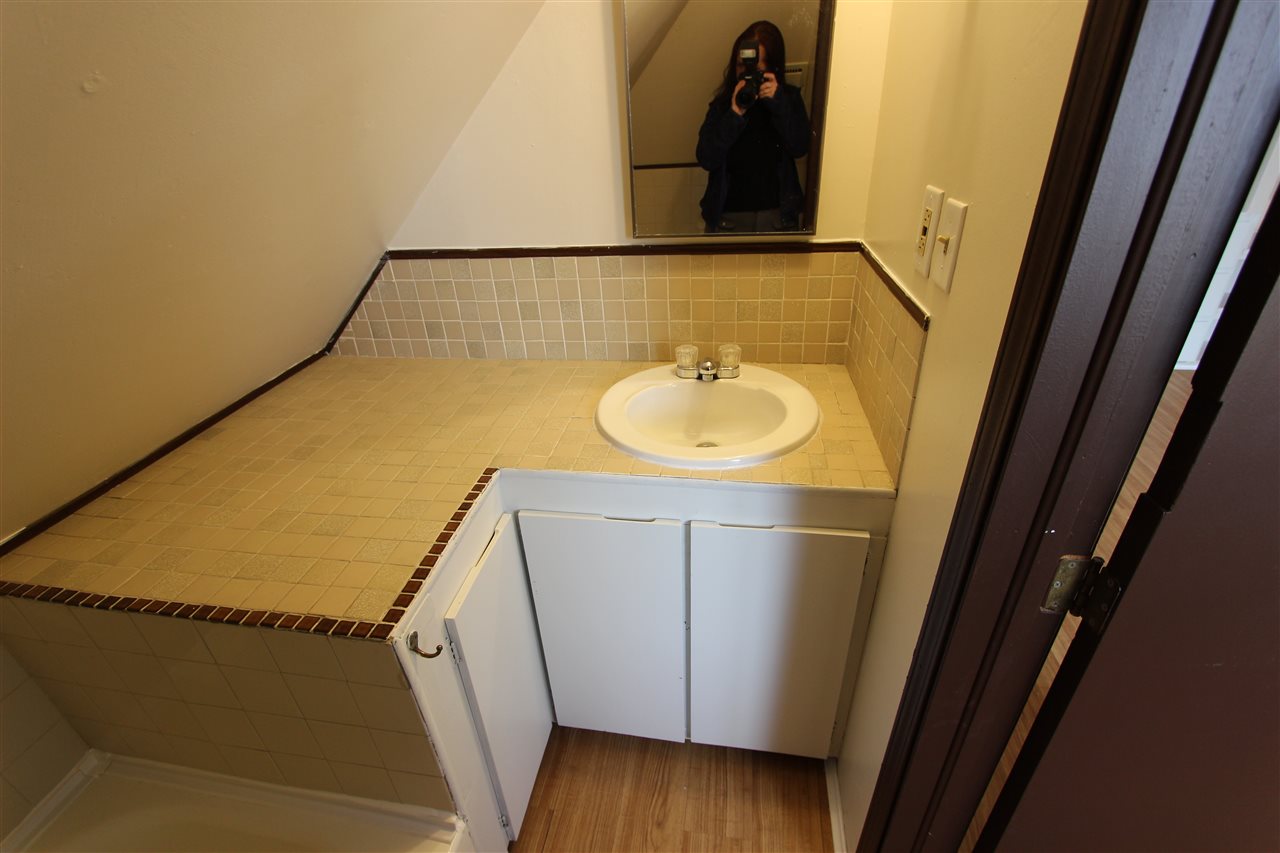 1011 Rood Avenue, Unit C Grand Junction, CO 81501 - Photo 8 of 8 a bathroom with a sink and mirror
