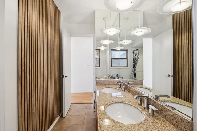 a view of empty room with wooden floor and ceiling fan