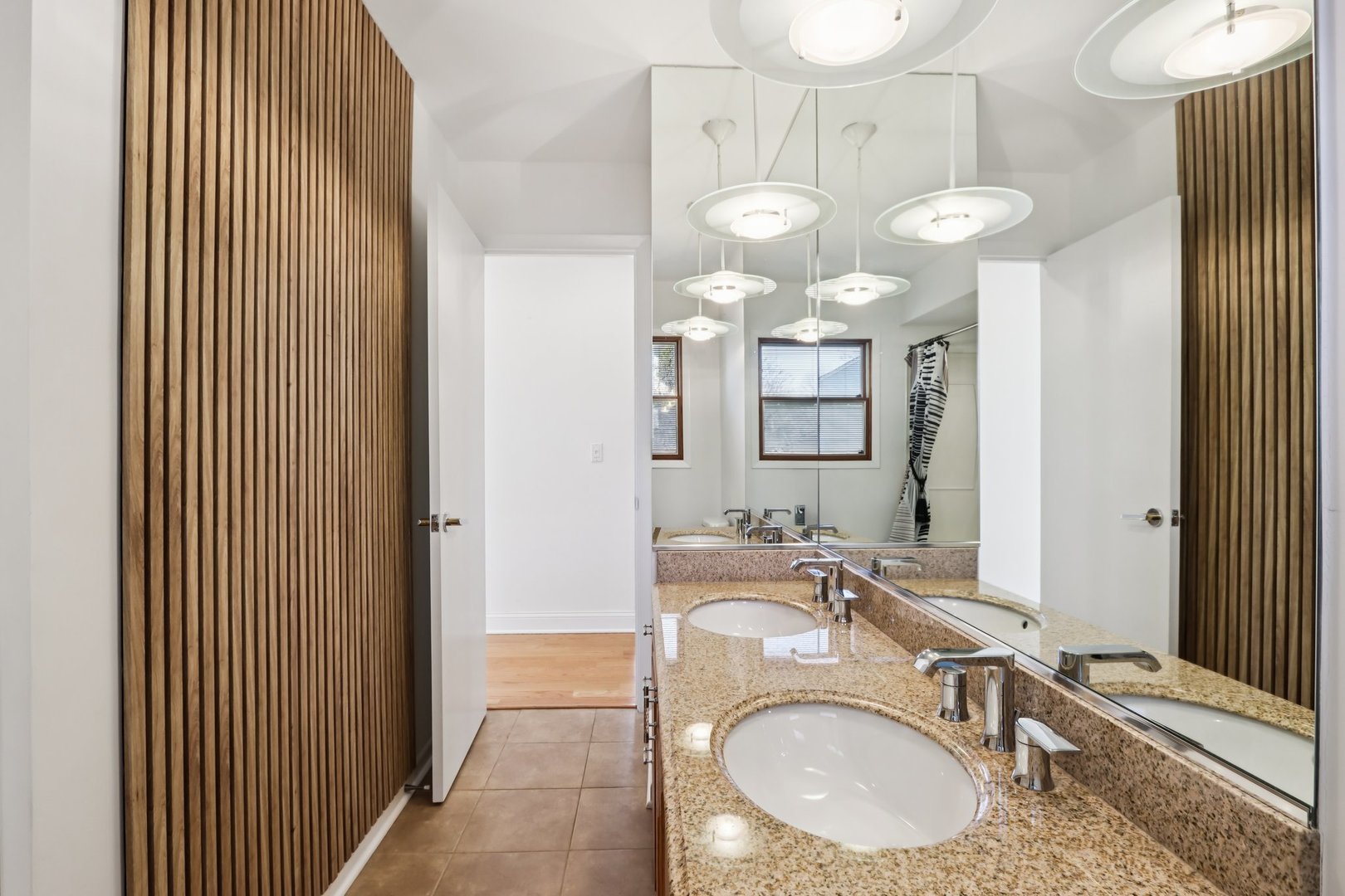 2019 East Avon Lane Arlington Heights, IL 60004 - Photo 17 of 59 a bathroom with a granite countertop sink a mirror and a shower