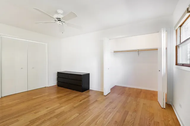 a living room with a wooden floor and furniture