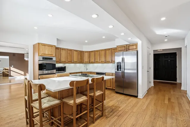 a view of a livingroom with wooden floor and a ceiling fan