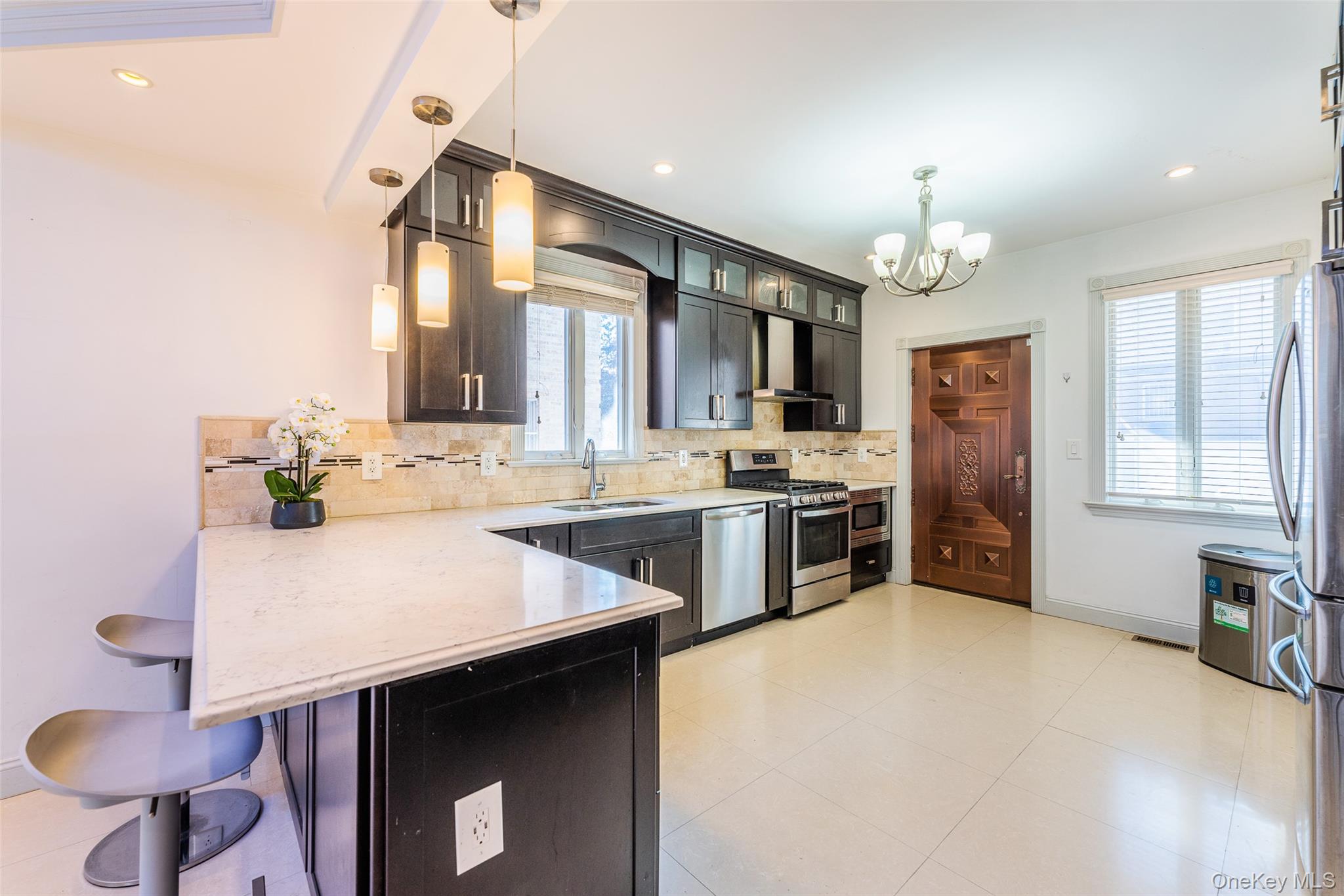 53-12 199th Street Queens, NY 11365 - Photo 12 of 31 a kitchen with stainless steel appliances a sink stove and refrigerator