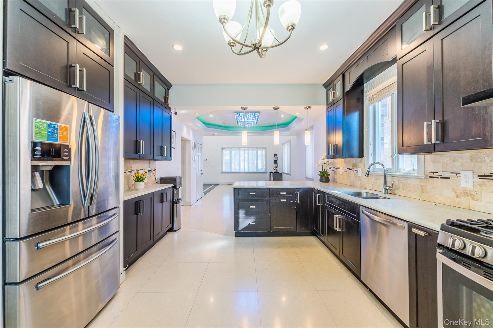 53-12 199th Street Queens, NY 11365 - Photo 13 of 31 a kitchen with stainless steel appliances granite countertop a refrigerator a sink dishwasher a stove and a dining table with wooden floor