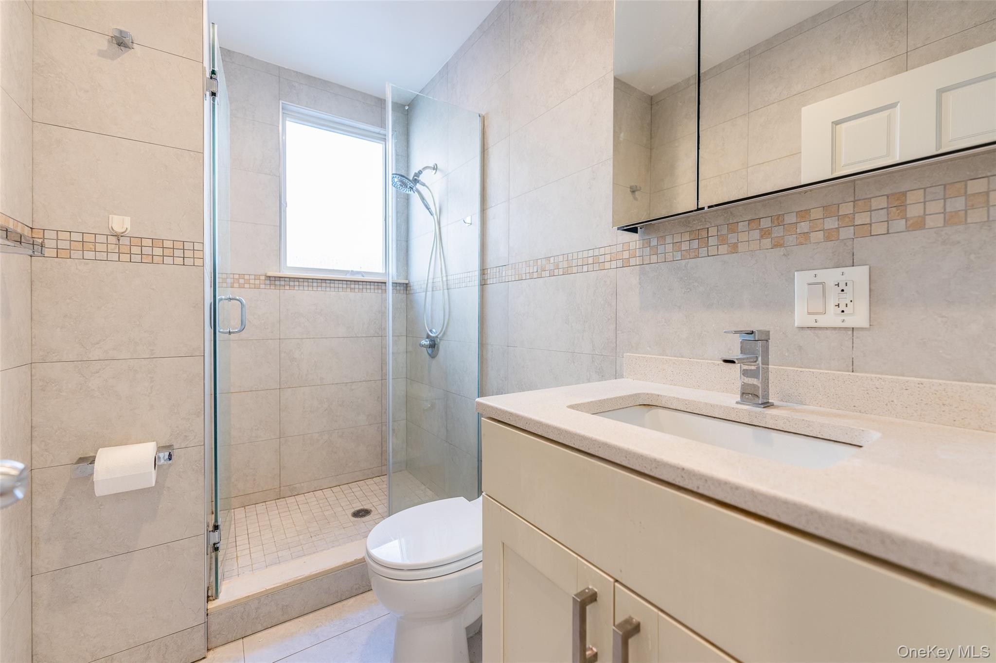 53-12 199th Street Queens, NY 11365 - Photo 16 of 31 a bathroom with a sink a toilet and shower