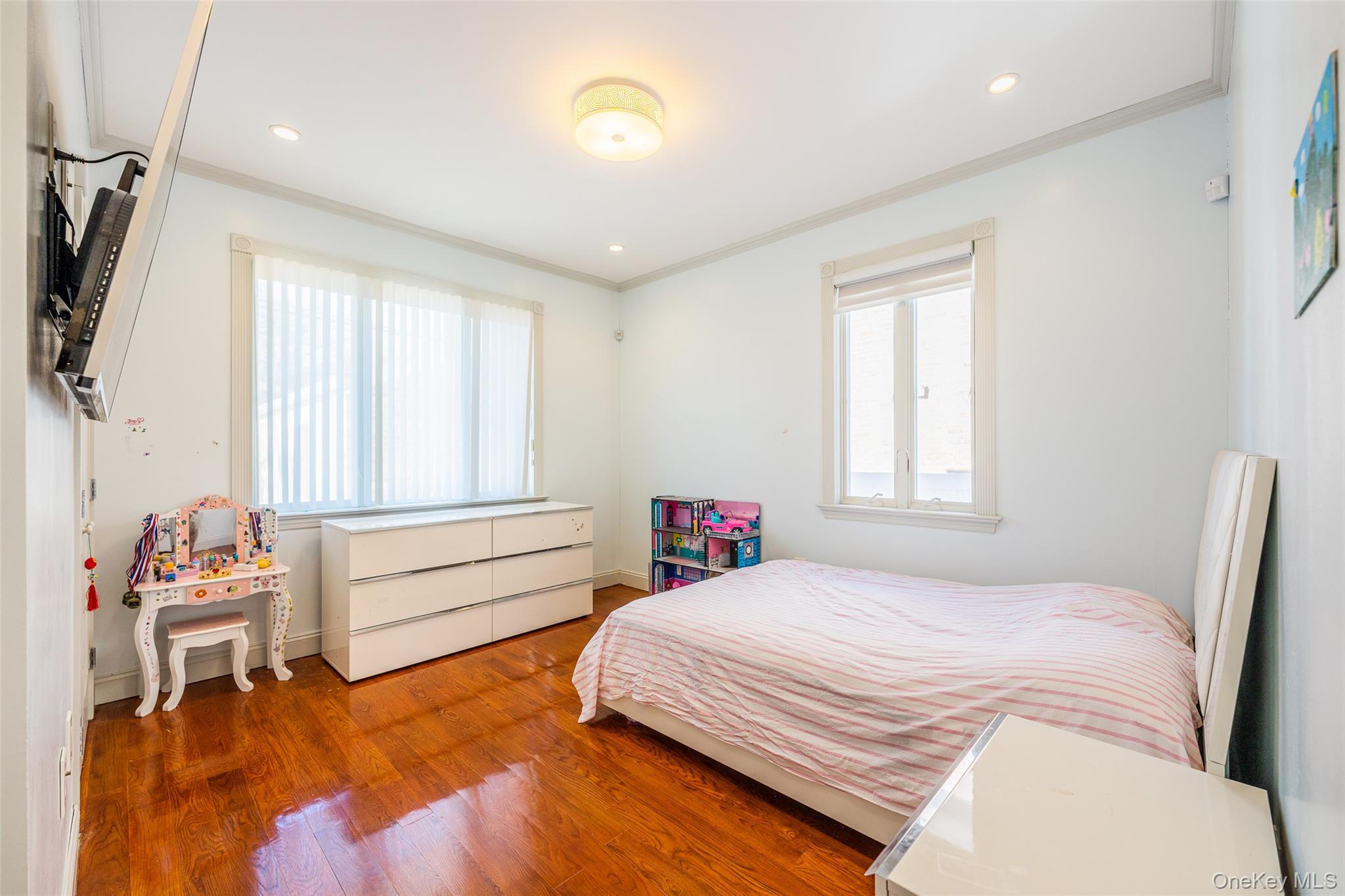 53-12 199th Street Queens, NY 11365 - Photo 17 of 31 a bedroom with a bed and a television