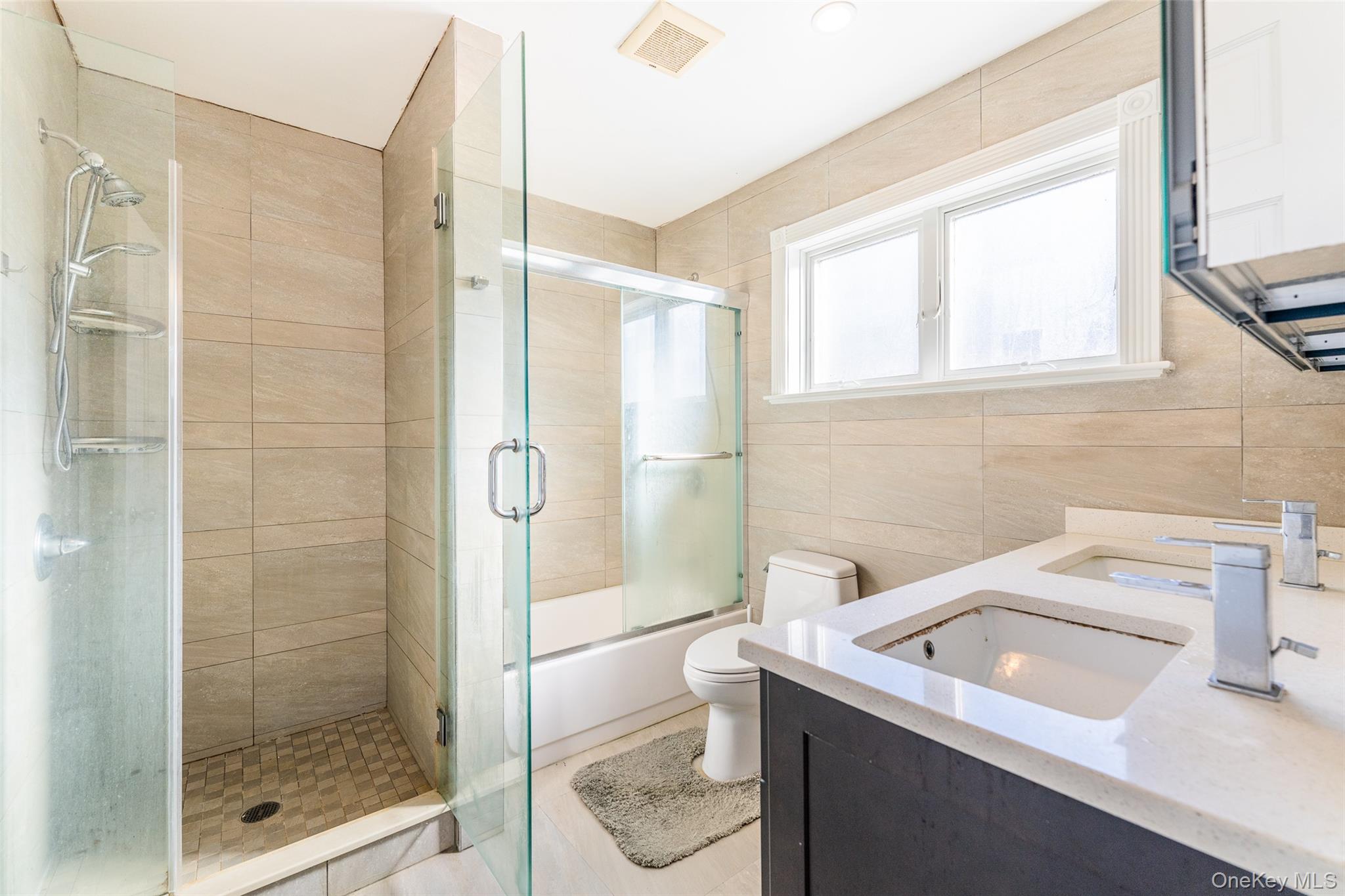 53-12 199th Street Queens, NY 11365 - Photo 20 of 31 a bathroom with a granite countertop sink a toilet and shower