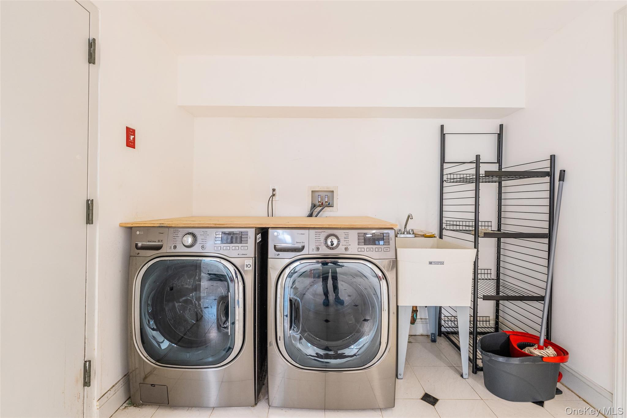 53-12 199th Street Queens, NY 11365 - Photo 23 of 31 a utility room with dryer and washer