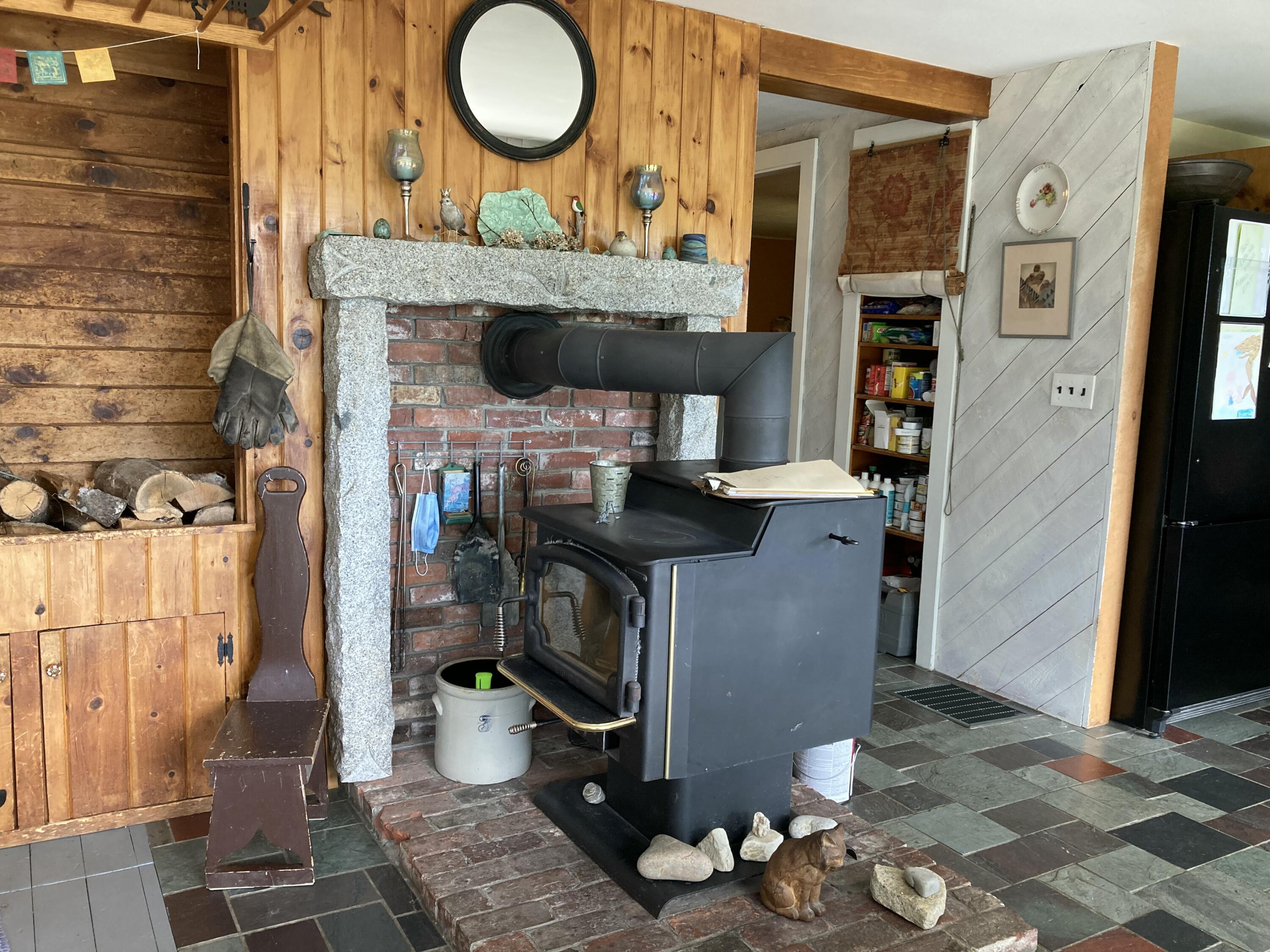 969 Surry Road Surry, ME 04684 - Photo 14 of 41 Wood stove between living & dining.