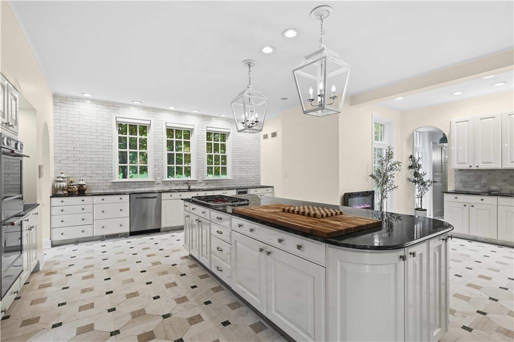 898 Persimmon Road Sewickley, PA 15143 - Photo 20 of 50 Anchored by an oversized island and framed by lantern pendants, the kitchen blends generous scale with refined detail, including new double ovens, a new six-burner Wolf range, and expansive windows.
