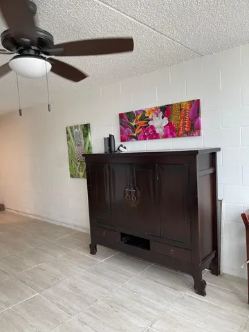 a living room with furniture a flat screen tv and a window