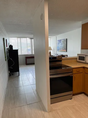 a living room with furniture and a ceiling fan