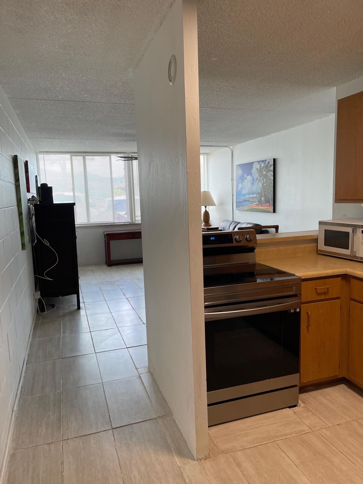 111 Kahului Beach Road, Unit D112 Kahului, HI 96732 - Photo 15 of 29 a kitchen with a stove and a refrigerator