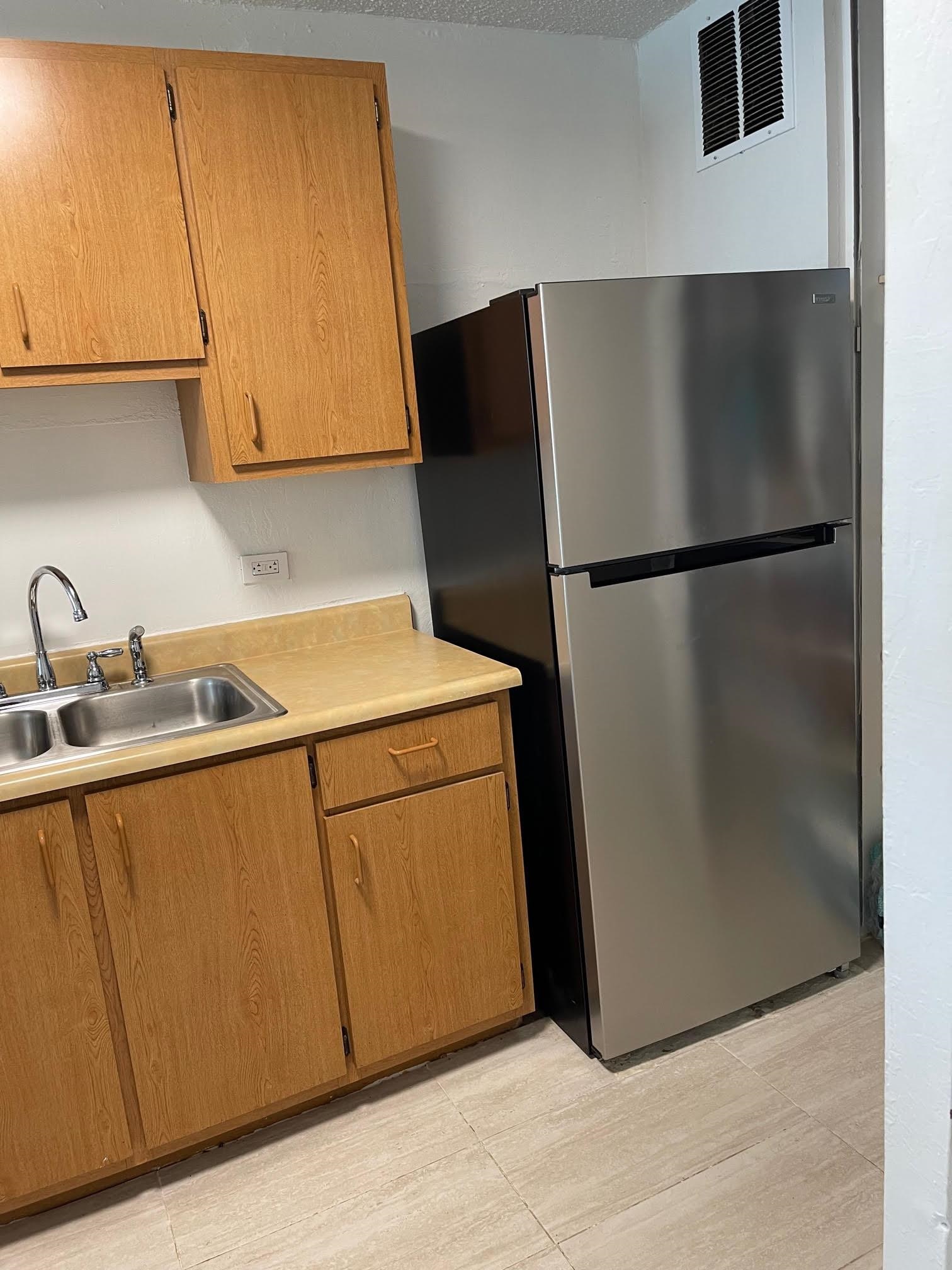 111 Kahului Beach Road, Unit D112 Kahului, HI 96732 - Photo 17 of 29 a kitchen with a refrigerator and a sink
