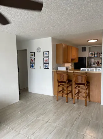 a view of a livingroom with furniture and a kitchen