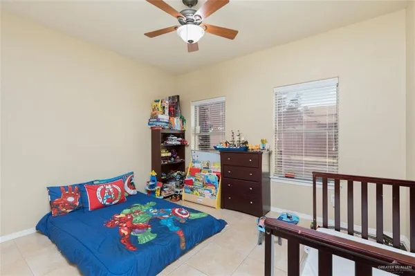 a living room with furniture and a baby crib